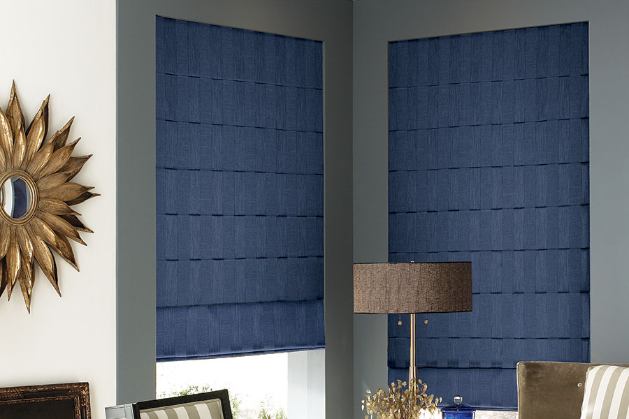 Dark blue Roman shades on corner windows in a living room.