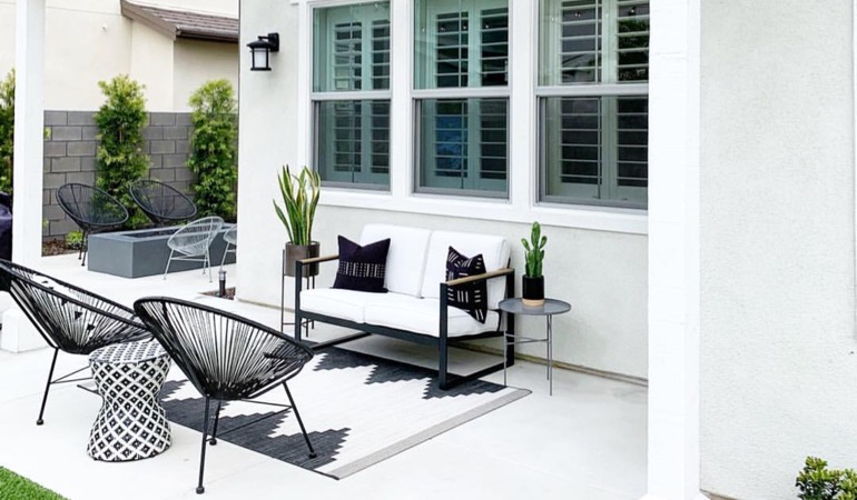 Spending a little time weeding and mulching can provide you with an outside oasis. Backyard with plantation window treatments