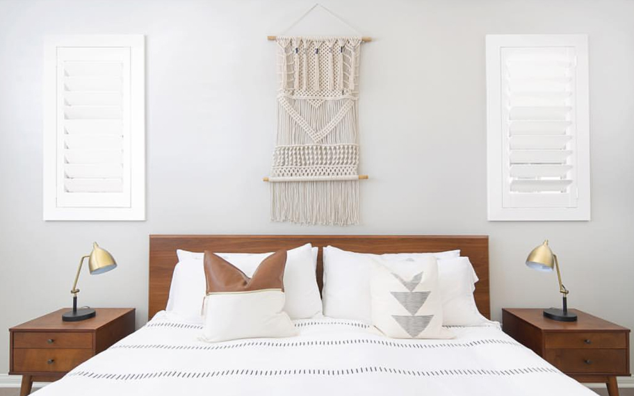 Custom-fitted louvered shutters provide excellent nighttime privacy in Sacramento. Photo Credit: Audrey Crisp Louvered shutters in a bedroom.