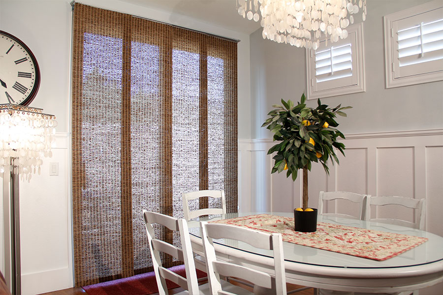 Woven brown shades in a classic style dining room