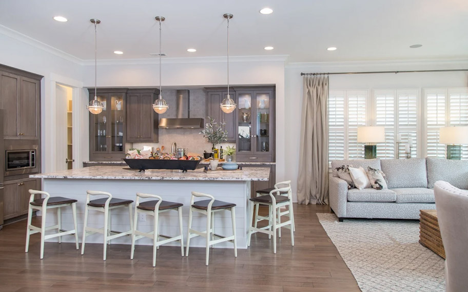 Illuminate your home with custom interior shutters in Sacramento. White arched shutters in a white kitchen with lots of light.