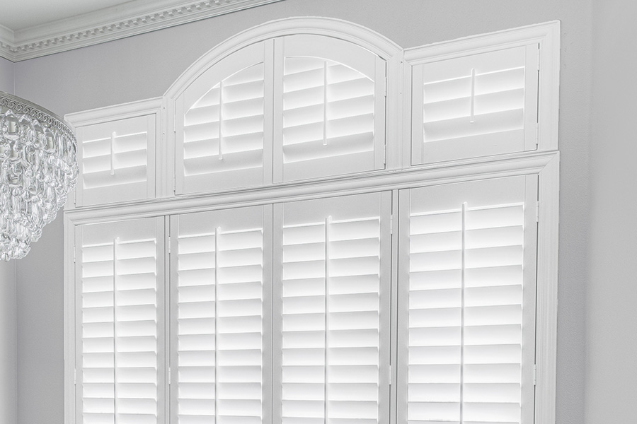 Customize your Palladian windows with white Polywood shutters in Sacramento. White Polywood Palladian windows in a dining room.