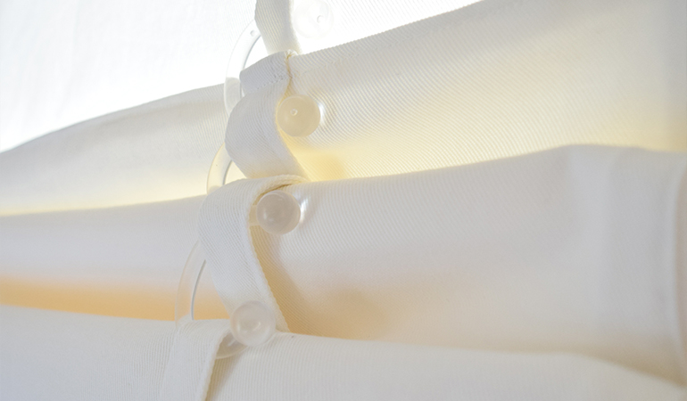 close up of white rolled tumble shades