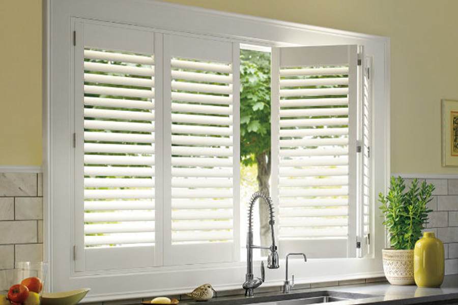 Polywood shutters are built to withstand the test of time in Sacramento. White Polywood shutters above a kitchen sink.