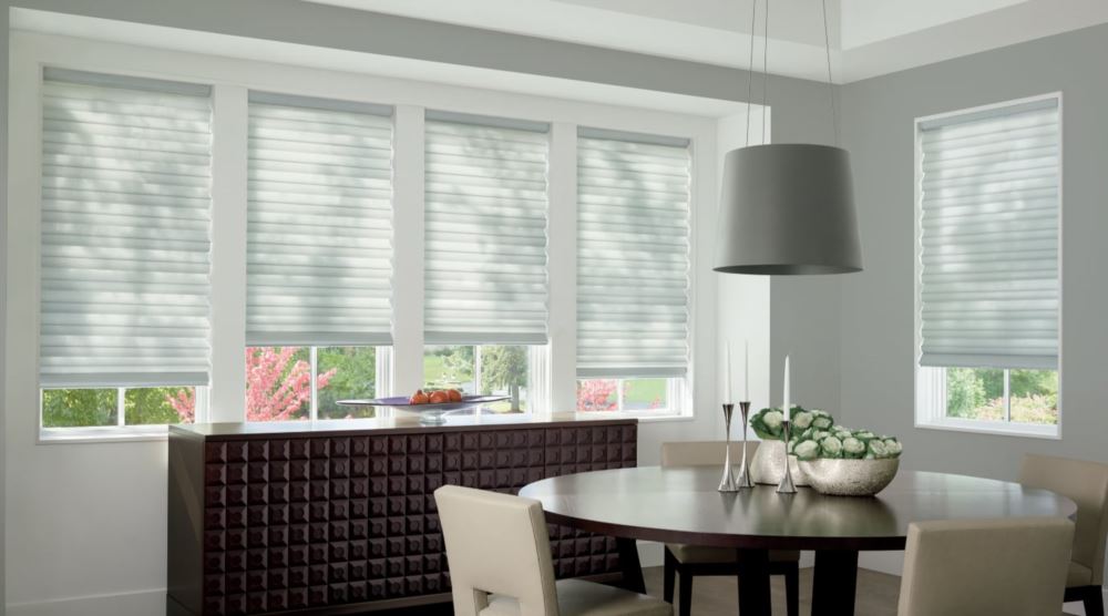 Custom cordless roller shades have a clean look and are appropriate for any room. Cordless motorized shades in a Sacramento dining room