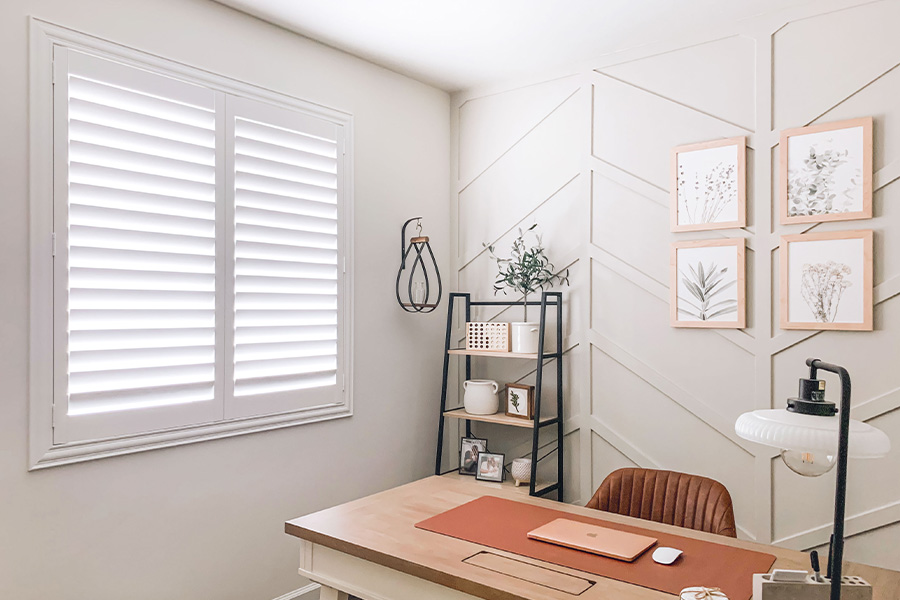 Polywood shutters give you maximum control over natural light in your Sacramento home. Photo Credit: @OurLakepoint Farmhouse  White and off-white farmhouse style office with natural light from polywood shutters.