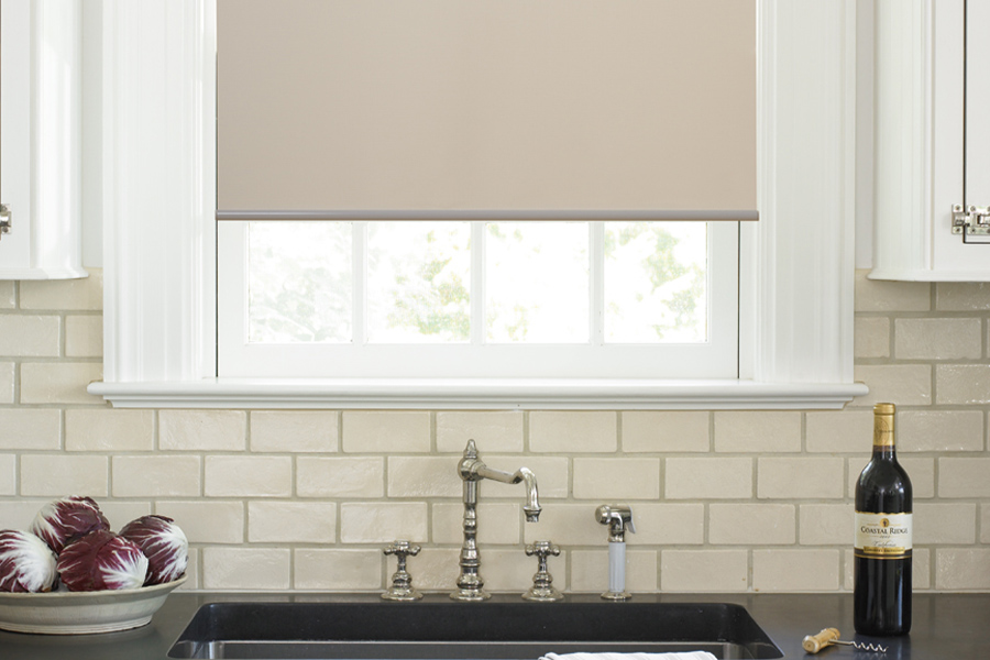 Roller shades opens up a lot of color and style options for your gourmet kitchen at Sacramento. Roller shade above a kitchen sink.